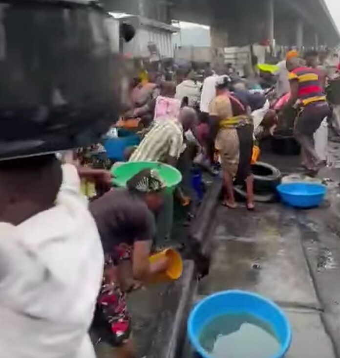 Near-Death Scene as Crowd Scoops Fuel from Overturned Tanker in Apapa